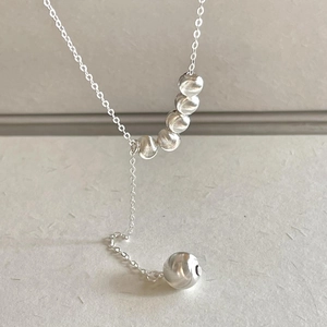 Minimalist S925 sterling silver Y-shaped necklace with spiral textured beads on gray background