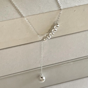Minimalist 925 silver Y-shaped bead necklace with spiral textures and a polished pendant