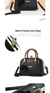Detail of black lychee leather handbag with amber resin handles and rhinestone lock