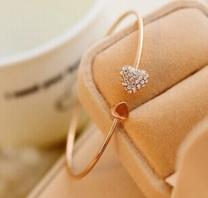 Detail of rose gold open heart bracelet with sparkling zircon stones in gift box