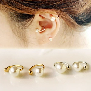 Detail of four-piece pearl ear cuff set in gold and silver finish on model