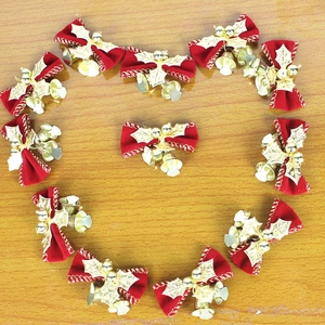 Set of 12 red velvet Christmas bows with gold bells and holly leaves on wood