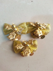 Three-piece set of gold Christmas bows with bells and holly leaves for tree decor