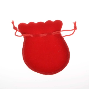 Macro shot of red velvet drawstring pouch with petal edge for jewelry packaging