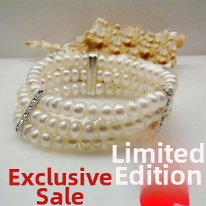 Detailed close-up of a three-layer pearl bracelet with sparkling silver rhinestone spacers