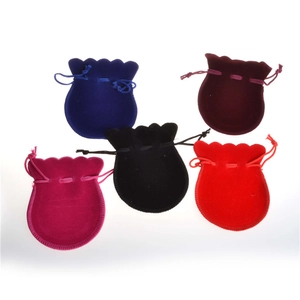 Detailed view of drawstring velvet jewelry pouches in five vibrant assorted colors