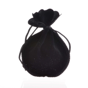 Close-up of a small black velvet drawstring pouch for jewelry packaging