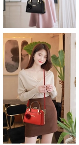 Close-up of litchi texture leather handbags with golden handles and floral charms