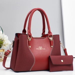 Fashionable contrast stitching red leather handbag set with floral decor on white background