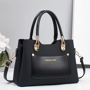 Elegant black faux leather tote bag with vertical texture and golden fashion lettering