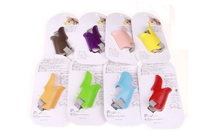 Eight colors of silicone duck-shaped dog muzzles displayed in a grid with retail packaging