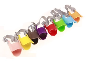 Duck-billed silicone dog muzzles shown in eight vibrant colors with grey nylon straps