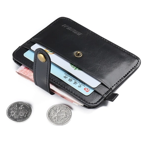 Detail of black leather wallet showing multiple card slots and bronze snap button closure