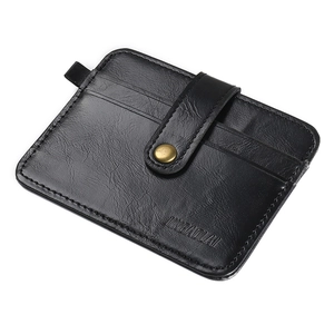Macro shot of black pebbled leather wallet with multiple card slots and bronze snap button