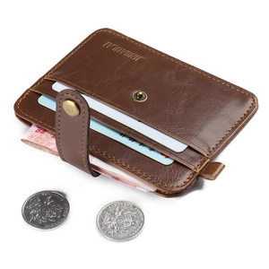 Detail of dark brown leather card holder featuring multi-layer slots and metallic snap closure