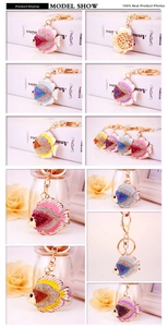 Detail of crystal-encrusted tropical fish keychain with hollow-out gold metal back pattern