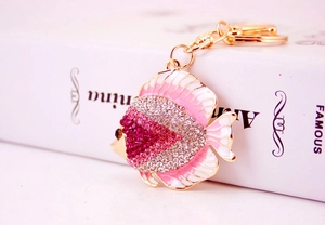 Close-up of pink tropical fish keychain with sparkling rhinestones and golden lobster clasp