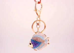 Detailed view of a golden tropical fish keychain with blue and silver rhinestones