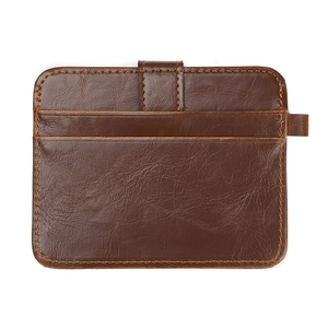 Macro view of vintage dark brown leather card holder with sturdy yellow stitching and buckle
