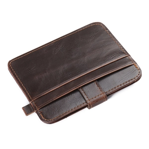 Close-up of slim dark brown leather card holder with lychee grain and contrast stitching