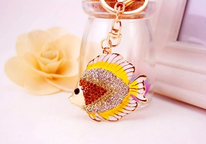 Macro shot of colorful rhinestone tropical fish keychain with gold-tone enamel finish