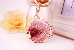 Detailed close-up of pink and gold tropical fish keychain with sparkling rhinestones