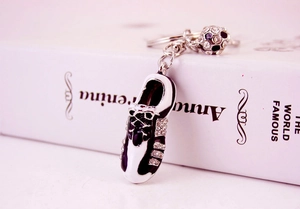 Macro shot of a sparkling crystal-studded miniature football and soccer cleat keychain