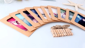 Close-up of DIY kraft paper photo frames with wooden clips and natural jute twine sets