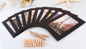 Detail of 10 black paper photo frames with wooden clips and jute rope for DIY wall decor