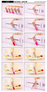 Detailed grid showing colorful rhinestone lipstick keychains with gold metal lobster clasps