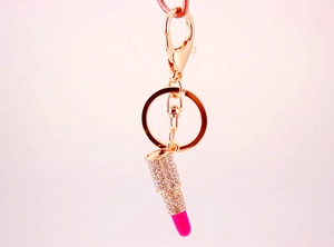 Detailed close-up of a rhinestone lipstick keychain with pink crystal accents
