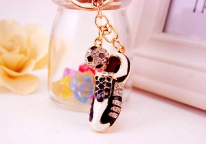 Detailed view of soccer shoe keychain with sparkling rhinestones and a ball pendant