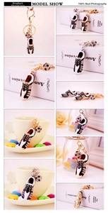 Detail view of rhinestone soccer shoe keychain with miniature ball and lobster clasp