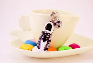 Detailed view of silver metal keychain with rhinestone football shoe and mini ball charms