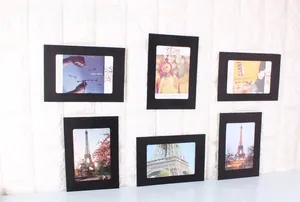 Detail of 6 black cardboard photo frames with twine and clips for wall decoration