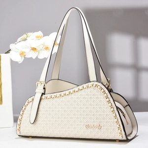 Minimalist cream woven tote bag with gold chain accents and adjustable shoulder strap