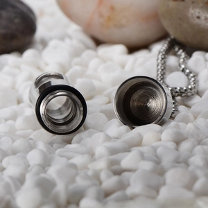 Silver stainless steel cylinder perfume bottle pendant necklace on white stones