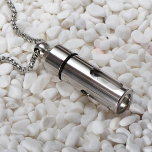 Polished stainless steel perfume bottle necklace pendant on white stones background