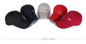 Detail view of cotton baseball caps in black, navy, beige, and red with Sport patch