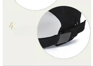 Detailed view of the black canvas baseball cap featuring an adjustable metal buckle strap