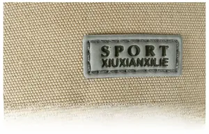 Close-up of beige canvas texture with a grey rectangular SPORT rubber logo patch