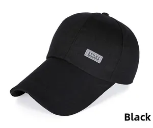 Detail of SPORT reflective patch on a black canvas baseball cap with long visor