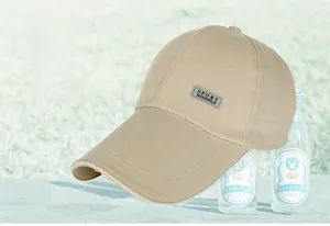 Detail of khaki cotton baseball cap with long brim and reflective SPORT tag on side
