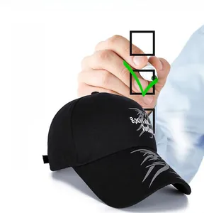 Detail view of black canvas baseball cap with long brim and white geometric patterns
