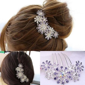 Detail of floral rhinestone hair comb with purple crystals and rainbow centerpiece