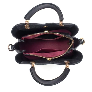 Top view of black wavy leather handbag showing three compartments and burgundy lining