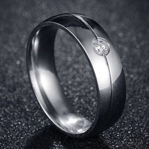Polished silver stainless steel ring featuring a single zircon stone and grooved center