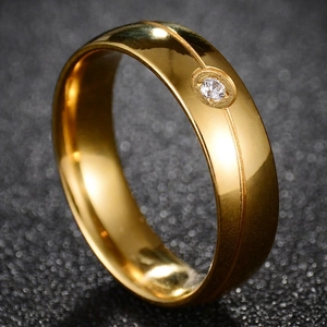 Polished 316L gold stainless steel band ring featuring a single inset cubic zirconia stone