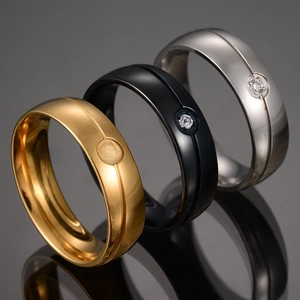 Macro shot of three-color stainless steel rings with a single cubic zirconia stone