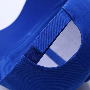 Detailed close-up of blue cotton baseball cap showing adjustable velcro strap back